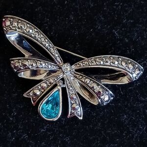 Vintage Avon silvertone bow brooch with turquoise colored pear shaped stone